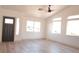 Bright living room featuring wood floors, a black front door, and large picture windows at 7413 Red Eagle St, Las Vegas, NV 89131