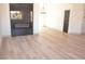 Bright living room featuring wood floors, a black marble fireplace, and a black interior door at 7413 Red Eagle St, Las Vegas, NV 89131
