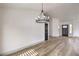 Spacious living room area featuring light hardwood floors and modern black door frames at 7413 Red Eagle St, Las Vegas, NV 89131