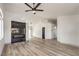 Open living space with wood floors, a modern fireplace, and contemporary ceiling fan at 7413 Red Eagle St, Las Vegas, NV 89131