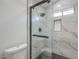 Contemporary shower with marble-style tile, black hardware, and a built-in niche at 7413 Red Eagle St, Las Vegas, NV 89131
