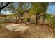 Spacious backyard featuring mature trees, a concrete patio, and a privacy fence at 9017 Wolf Dancer Ave, Las Vegas, NV 89143