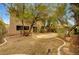 Large backyard with desert landscaping, concrete patio, and a two-story house at 9017 Wolf Dancer Ave, Las Vegas, NV 89143