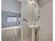 This bathroom features a pedestal sink and tile floors at 9017 Wolf Dancer Ave, Las Vegas, NV 89143