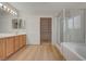 Main bathroom with double vanity, walk-in closet, and glass shower at 9017 Wolf Dancer Ave, Las Vegas, NV 89143