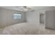 Bedroom with neutral walls, carpet, a window view, and a glimpse into an adjacent room at 9017 Wolf Dancer Ave, Las Vegas, NV 89143