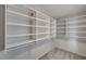 Spacious walk-in closet featuring custom white shelving and ample storage space at 9017 Wolf Dancer Ave, Las Vegas, NV 89143