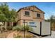 Two-story home with desert landscaping and a portable storage container on the driveway at 9017 Wolf Dancer Ave, Las Vegas, NV 89143