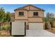 Two-story home with a two-car garage and neutral paint scheme, plus a portable storage container on the driveway at 9017 Wolf Dancer Ave, Las Vegas, NV 89143