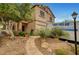 Charming two-story home with desert landscaping and a stone walkway leading to the front door at 9017 Wolf Dancer Ave, Las Vegas, NV 89143