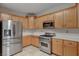 This kitchen features stainless steel appliances, light-colored cabinets, and white countertops at 9017 Wolf Dancer Ave, Las Vegas, NV 89143
