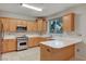 Well-equipped kitchen features plentiful cabinetry, stainless appliances, and sleek countertops for meal prep at 9017 Wolf Dancer Ave, Las Vegas, NV 89143