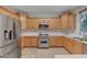 This kitchen features stainless steel appliances, light-colored cabinets, and white countertops at 9017 Wolf Dancer Ave, Las Vegas, NV 89143