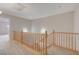 Carpeted upstairs landing with wood railing and neutral wall paint at 9017 Wolf Dancer Ave, Las Vegas, NV 89143