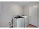 Laundry room with a side-by-side washer and dryer and a utility door at 9017 Wolf Dancer Ave, Las Vegas, NV 89143