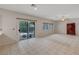 Bright living room with a sliding glass door, windows, and tile floors for easy maintenance at 9017 Wolf Dancer Ave, Las Vegas, NV 89143