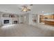 Open concept living room with fireplace and seamless flow into the kitchen at 9017 Wolf Dancer Ave, Las Vegas, NV 89143
