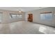 Spacious living room with tile flooring, neutral walls, and ample natural light from multiple windows at 9017 Wolf Dancer Ave, Las Vegas, NV 89143