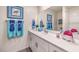 Well-lit bathroom with white cabinets, a single sink, and turquoise accents at 4755 Bluebird Cliffs Ave Dr # Lot 173, Las Vegas, NV 89141