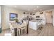 Spacious open concept kitchen with white cabinets, stainless steel appliances, and adjacent dining area at 4755 Bluebird Cliffs Ave Dr # Lot 173, Las Vegas, NV 89141