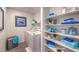 Well-organized laundry room with shelving, washer, dryer, and blue decor and accents at 4755 Bluebird Cliffs Ave Dr # Lot 173, Las Vegas, NV 89141