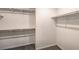 Empty walk-in closet with carpet and two shelves with rods on each side at 4755 Bluebird Cliffs Ave Dr # Lot 173, Las Vegas, NV 89141