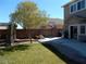 Spacious backyard featuring a well-manicured lawn, basketball hoop, and patio area, perfect for outdoor activities at 1004 Windy Ferrell Ave, North Las Vegas, NV 89081