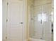 Bathroom highlighting an enclosed shower stall, door and tiled walls at 1004 Windy Ferrell Ave, North Las Vegas, NV 89081