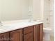 Modern bathroom featuring a double sink vanity with wood cabinets and a large mirror at 1004 Windy Ferrell Ave, North Las Vegas, NV 89081