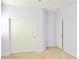 Bedroom features neutral carpet, lavender painted walls, white trim, and closet with sliding doors at 1004 Windy Ferrell Ave, North Las Vegas, NV 89081