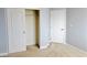 Bedroom with neutral carpet, light gray walls, a closet with sliding doors and white trim at 1004 Windy Ferrell Ave, North Las Vegas, NV 89081