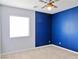 Bedroom features a two-tone paint scheme, carpeted floor, and a lighted ceiling fan at 1004 Windy Ferrell Ave, North Las Vegas, NV 89081