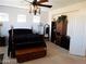Bedroom featuring a large bed with black bedding, wooden furniture and a ceiling fan at 1004 Windy Ferrell Ave, North Las Vegas, NV 89081