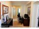 View of hallway with beige carpet, white walls and dark wood furniture and artwork at 1004 Windy Ferrell Ave, North Las Vegas, NV 89081