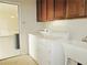 Functional laundry area with a sink, cabinets, and washer and dryer at 1004 Windy Ferrell Ave, North Las Vegas, NV 89081