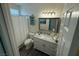 Well-lit bathroom with vanity, framed mirror, and shower with curtain, offering a clean and functional space at 10071 Lemon Valley Ave, Las Vegas, NV 89147