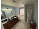 Bathroom with dual vanity sinks, tub, and patterned tile at 10071 Lemon Valley Ave, Las Vegas, NV 89147