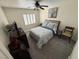 Cozy bedroom with a queen-size bed, ceiling fan, and shuttered window for a comfortable ambiance at 10071 Lemon Valley Ave, Las Vegas, NV 89147
