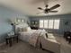 Bedroom with a sitting couch, ceiling fan, and bright window at 10071 Lemon Valley Ave, Las Vegas, NV 89147