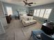 Bright bedroom with blue walls, a ceiling fan, and a comfortable sitting area at 10071 Lemon Valley Ave, Las Vegas, NV 89147