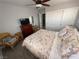 Bright bedroom with a ceiling fan, closet and dresser with a TV at 10071 Lemon Valley Ave, Las Vegas, NV 89147