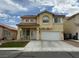 Charming two-story home with a well-manicured lawn and a two-car garage at 10071 Lemon Valley Ave, Las Vegas, NV 89147