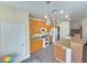 Kitchen with wood cabinets, white appliances, gray flooring, and a large island with bar seating at 10071 Lemon Valley Ave, Las Vegas, NV 89147