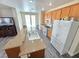 This open kitchen features an island, oak cabinets, stainless steel appliances and provides backyard access at 10071 Lemon Valley Ave, Las Vegas, NV 89147