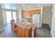 Bright kitchen features an island, oak cabinets, stainless steel appliances, and sliding glass doors to the backyard at 10071 Lemon Valley Ave, Las Vegas, NV 89147