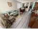 Bright living room featuring hardwood floors, comfortable seating, and a view into the dining area at 10071 Lemon Valley Ave, Las Vegas, NV 89147