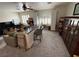 Expansive living room offers seating, a desk, a large window, and storage, perfect for relaxation and productivity at 10071 Lemon Valley Ave, Las Vegas, NV 89147