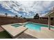 Sparkling in-ground pool and spa combination with a stone patio and blue skies at 10071 Lemon Valley Ave, Las Vegas, NV 89147