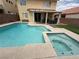 In-ground pool with a spa and a patio area for outdoor seating at 10071 Lemon Valley Ave, Las Vegas, NV 89147