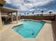 Inviting in-ground pool with a spa, concrete patio, and a covered seating area at 10071 Lemon Valley Ave, Las Vegas, NV 89147